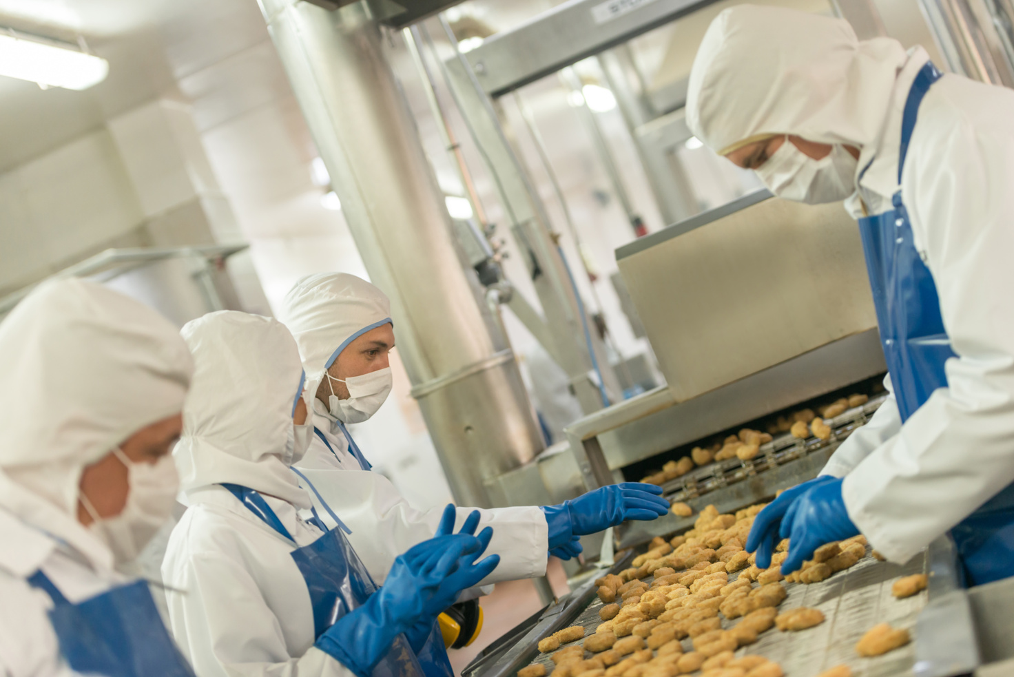 Workers at a food factory working at the production line