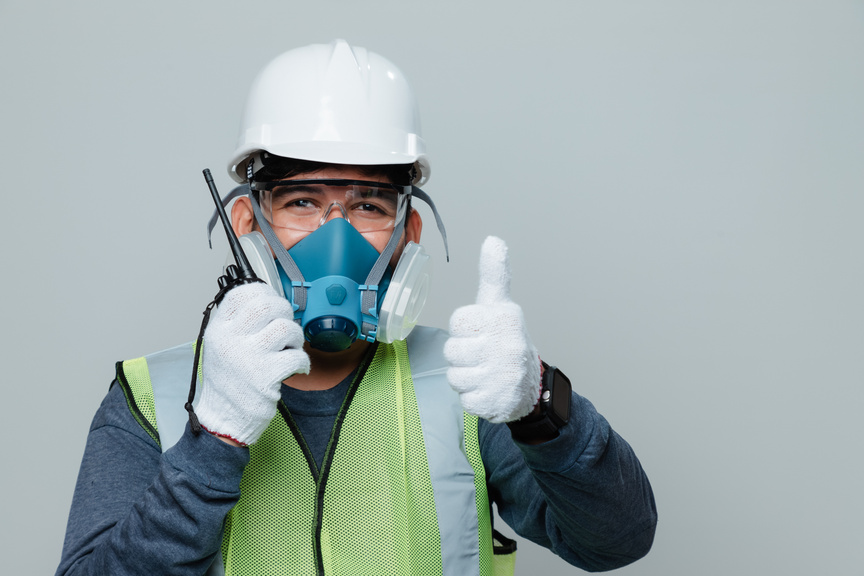 Man Wearing Hard Hat and Respirator